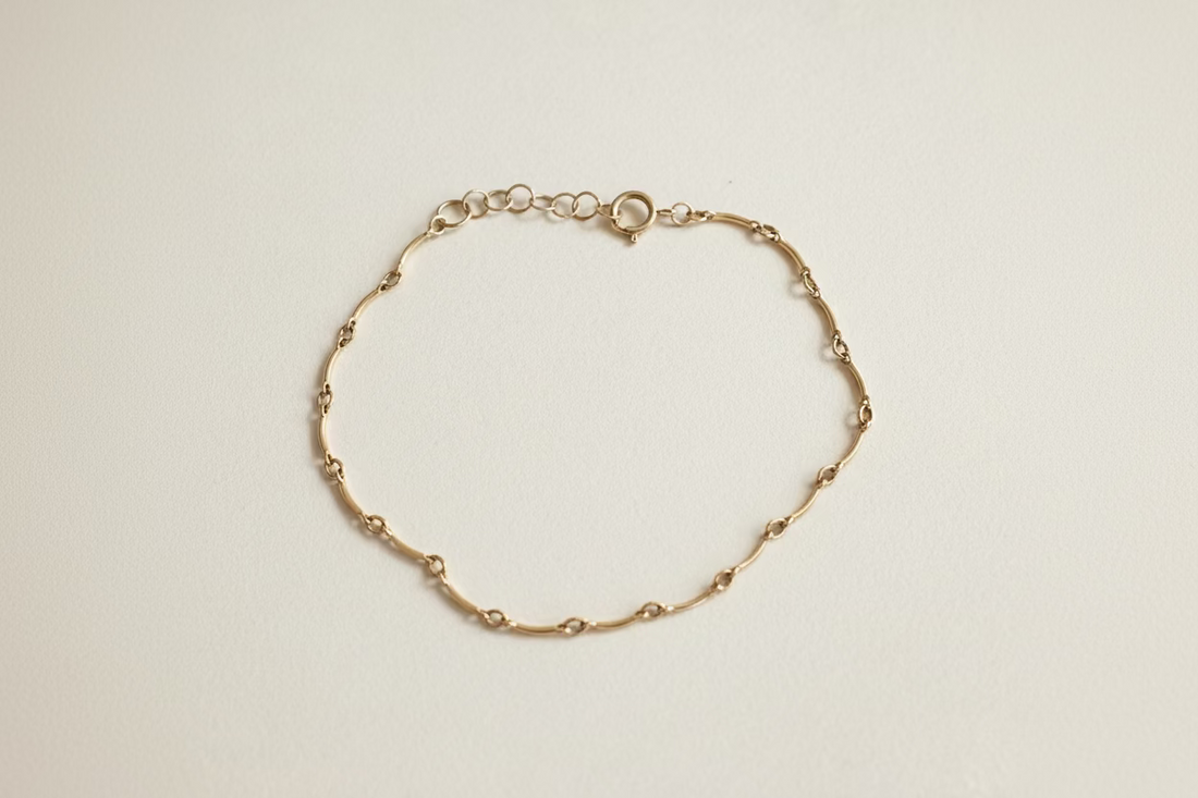 Gold bracelet on a cream  background