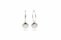 Silver shell earrings hanging against a neutral background by xomango
